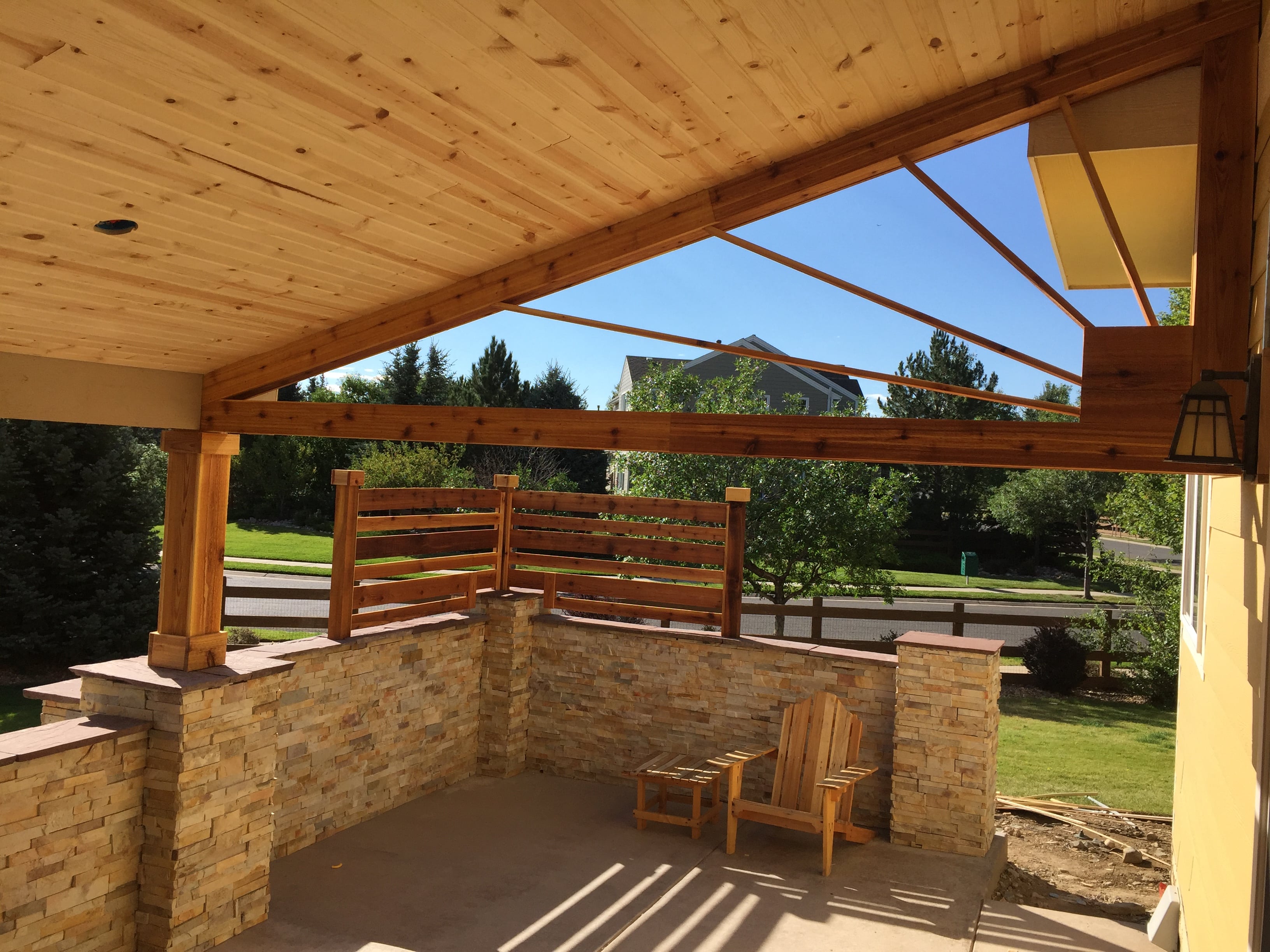 Norstone Aztec XLX Stacked Stone veneer panels used on a large outdoor kitchen with seating area